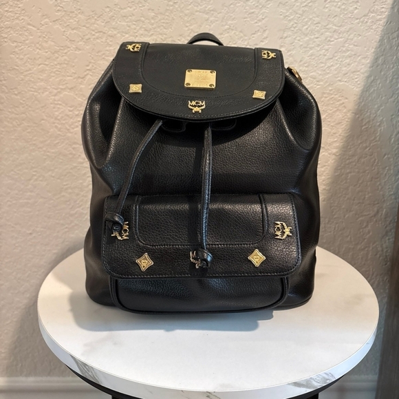 MCM Handbags - MCM Black Leather Backpack with Gold Accents